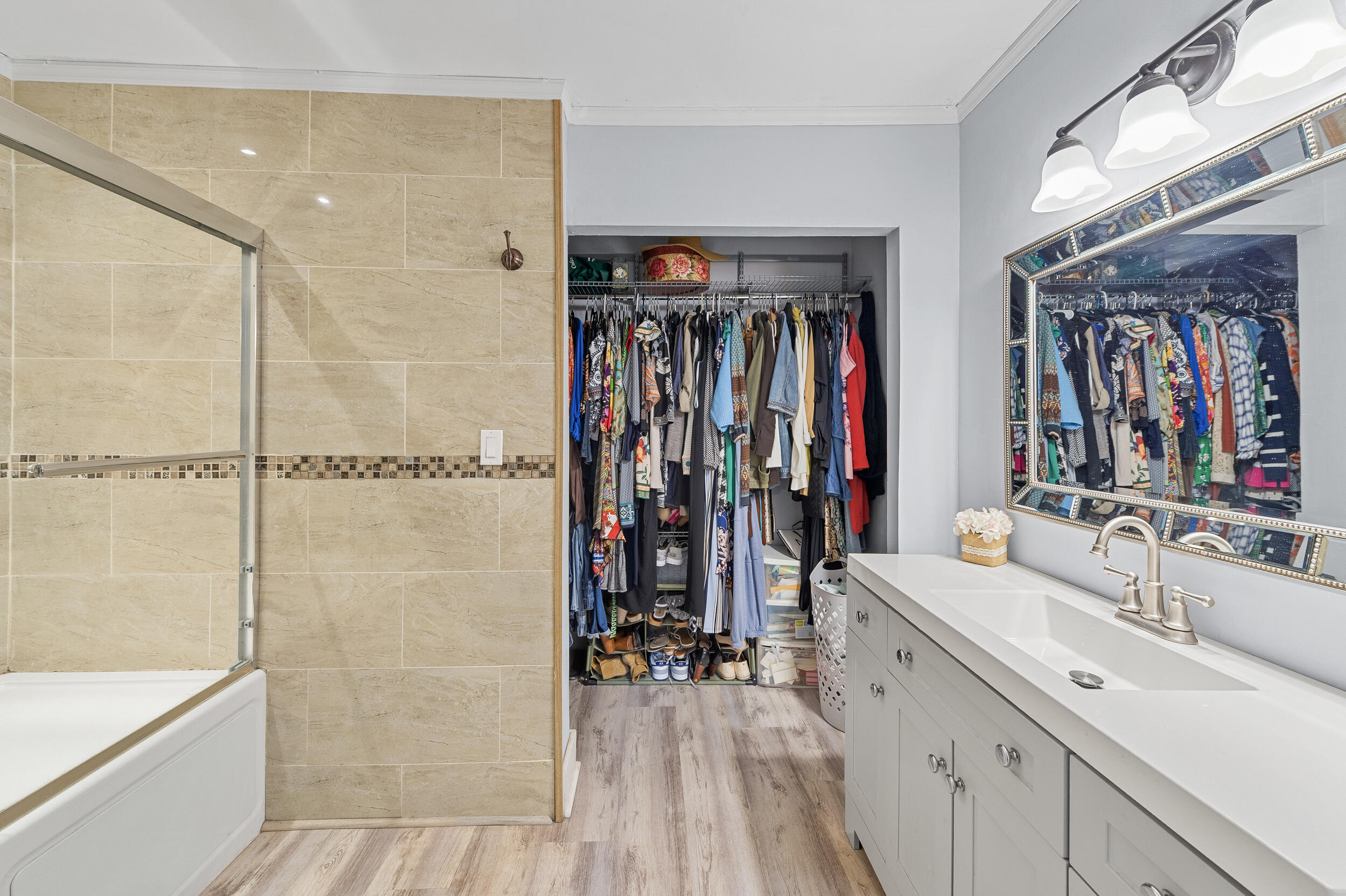 6548 Via Regina Boca Raton, FL 33433 - Photo 30 of 41 a bathroom with a double vanity sink a toilet and a shower