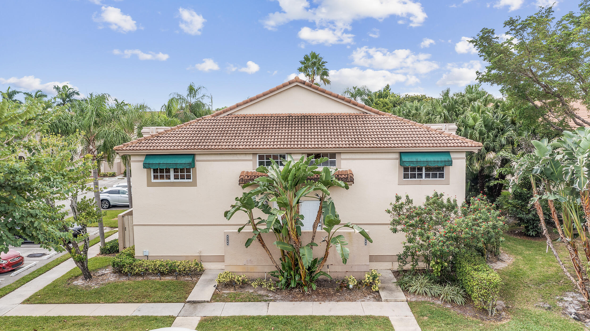 6548 Via Regina Boca Raton, FL 33433 - Photo 5 of 41 a front view of a house with garden