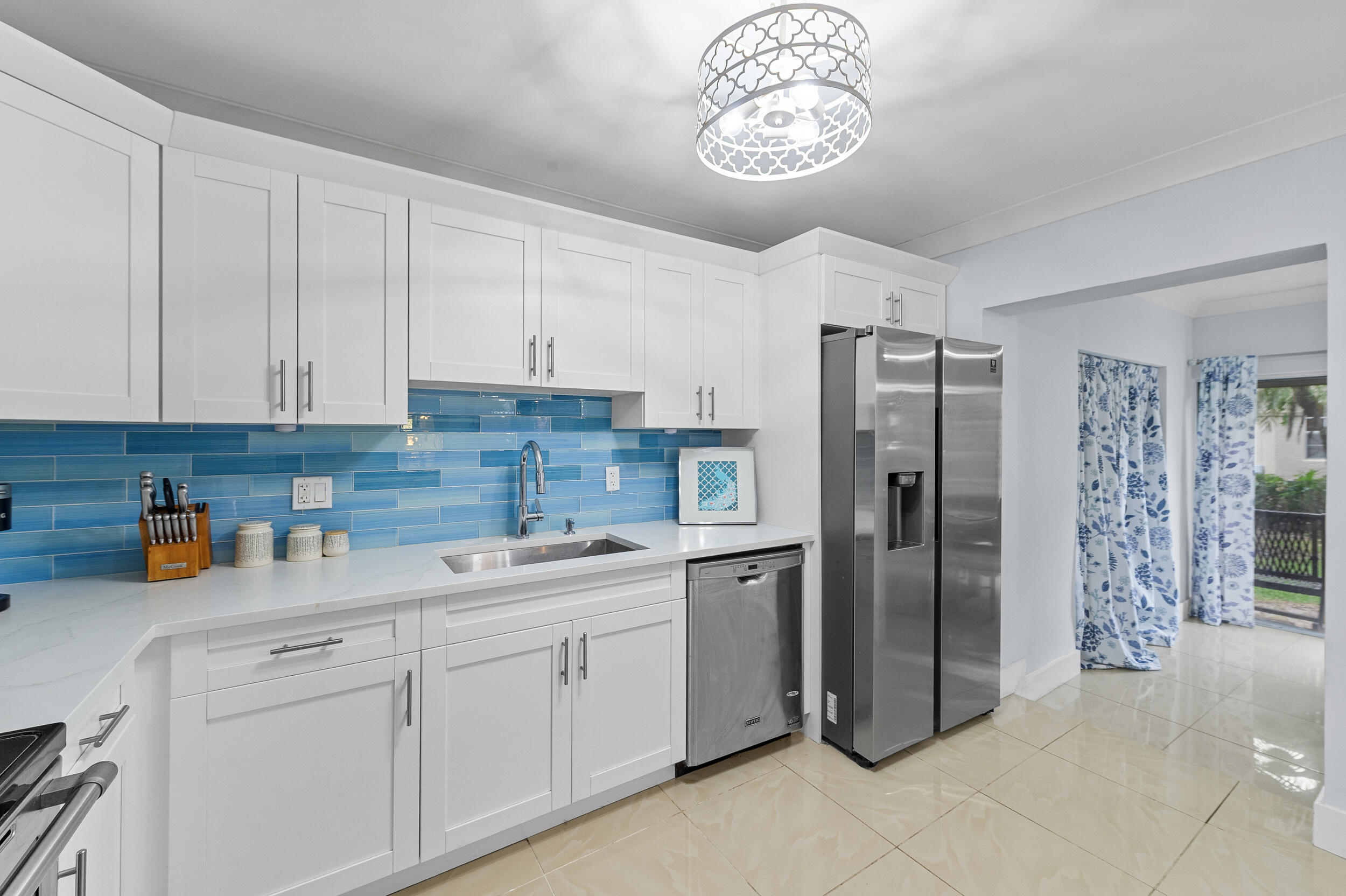 6548 Via Regina Boca Raton, FL 33433 - Photo 10 of 41 a kitchen with a refrigerator and cabinets