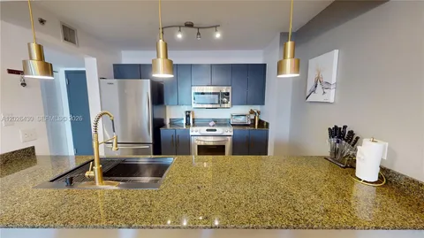 a kitchen with a refrigerator sink and stove