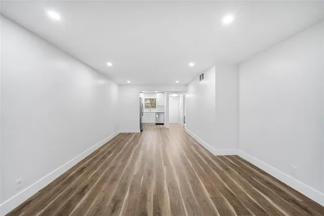 a view of a room with wooden floor
