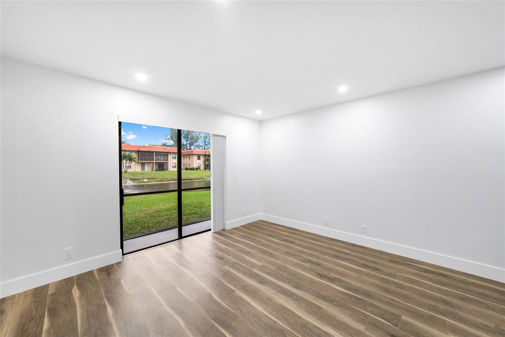 21905 Lake Forest Circle, Unit 101 Boca Raton, FL 33433 - Photo 17 of 23 a view of an empty room with wooden floor