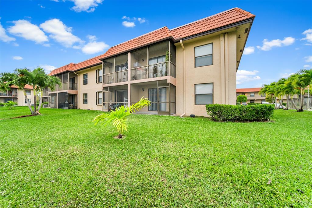 21905 Lake Forest Circle, Unit 101 Boca Raton, FL 33433 - Photo 23 of 23 a view of house with backyard