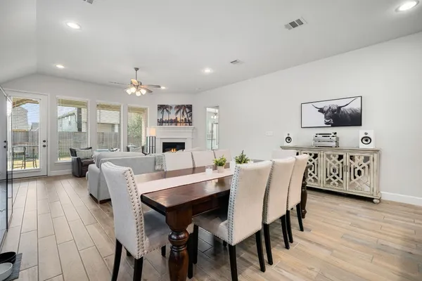 a view of a dining room with furniture and wooden floor