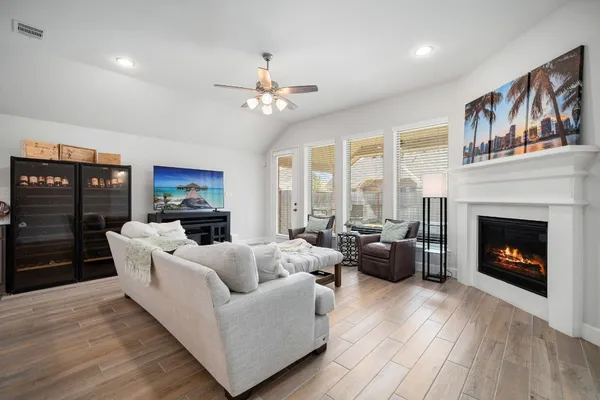 a living room with furniture a fireplace and a flat screen tv