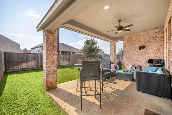a view of a porch with furniture and a yard