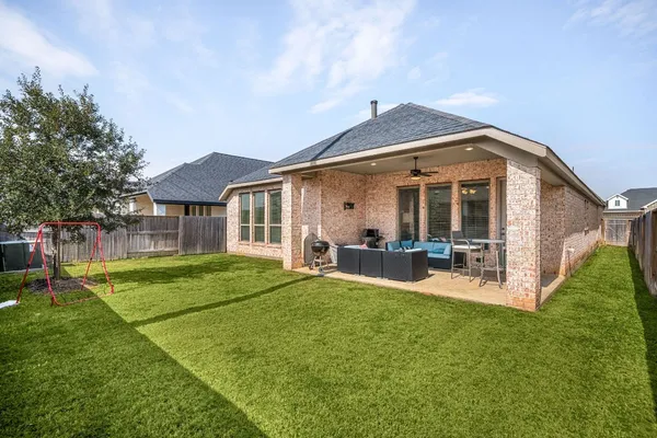 a view of a house with backyard porch and sitting area