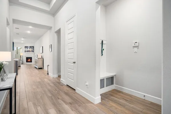 a view of a hallway with wooden floor