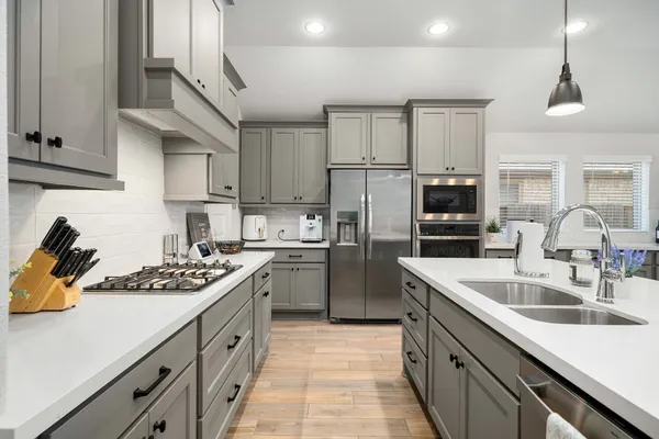 a kitchen with a sink stove and refrigerator