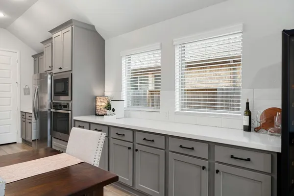 a kitchen with stainless steel appliances a sink a stove and a window