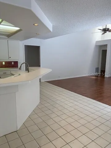 a hallway with a large mirror and a wooden floor