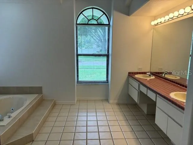 a room with washing machine and cabinets