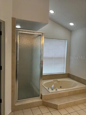 a bathroom with a tub shower and a sink