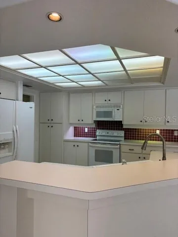 a kitchen with a stove and cabinets