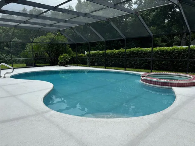 a view of a swimming pool with a yard