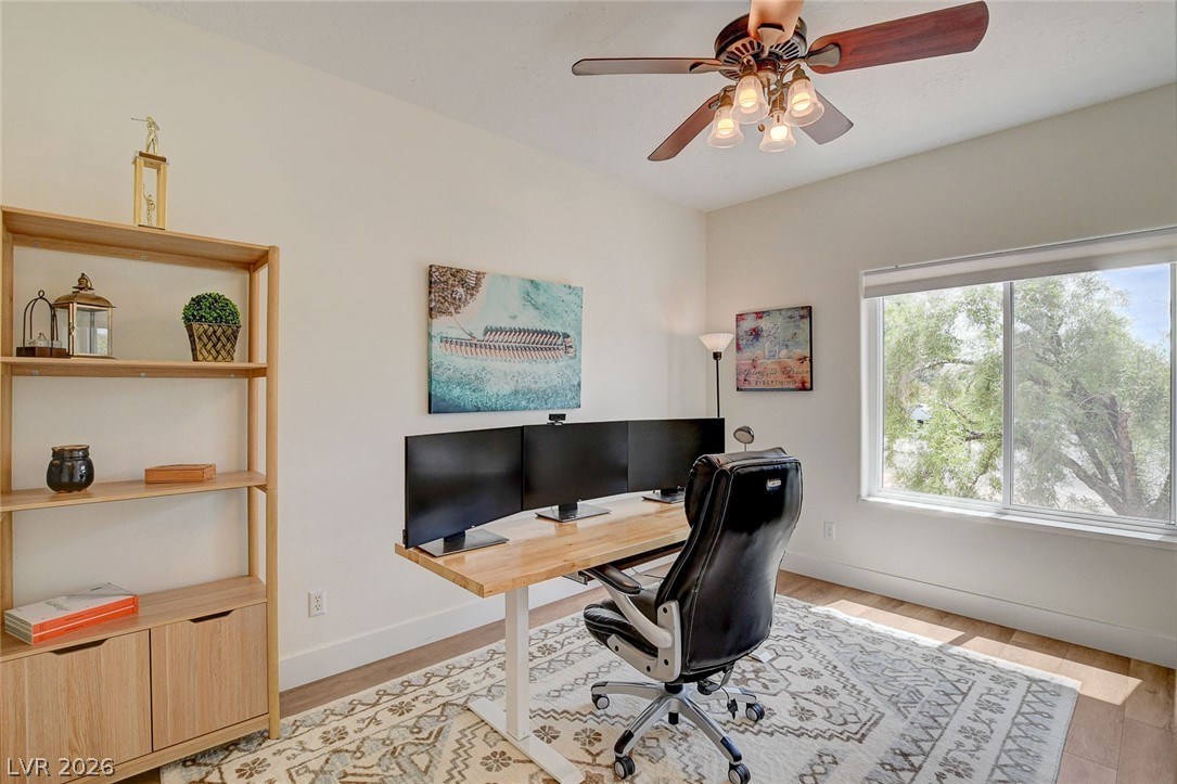 4362 Thistle Street Logandale, NV 89021 - Photo 35 of 99 Well-lit office space with LVP floors and a window view of mature trees.