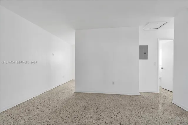 a bathroom with a granite countertop toilet a sink a window and vanity