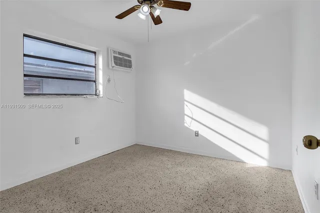 a view of empty room with ceiling fan