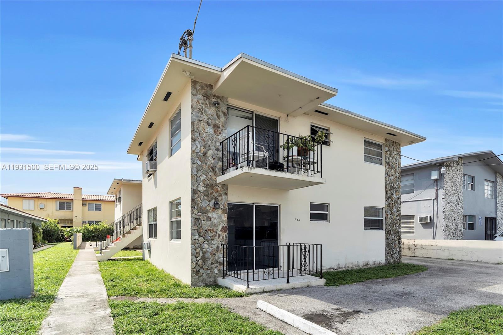 644 Southwest 10th Street, Unit 5 Miami, FL 33130 - Photo 2 of 26 a front view of a house with a yard