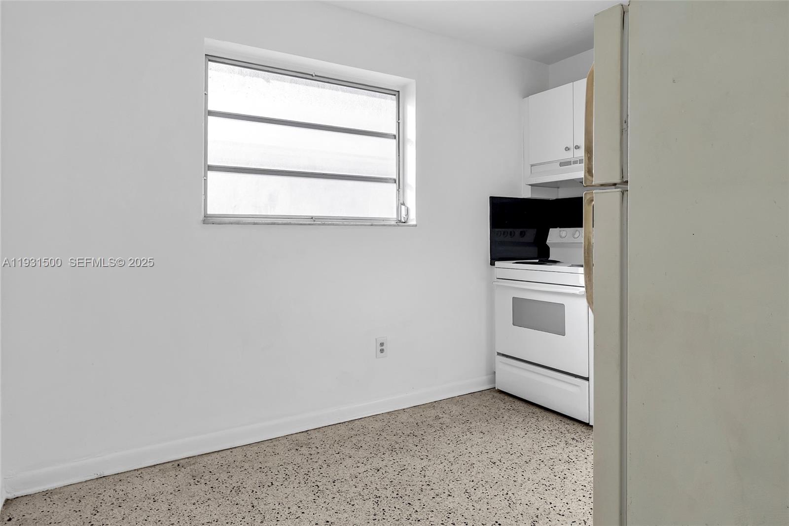644 Southwest 10th Street, Unit 5 Miami, FL 33130 - Photo 8 of 26 a view of a kitchen with white cabinets and white appliances