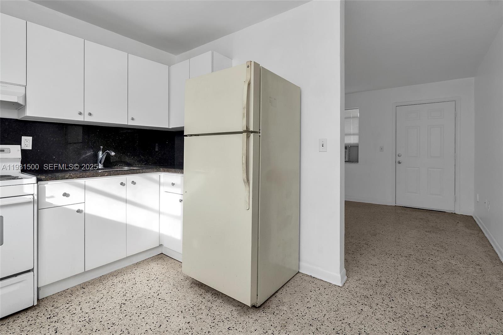 644 Southwest 10th Street, Unit 5 Miami, FL 33130 - Photo 10 of 26 a kitchen with a refrigerator sink and cabinets
