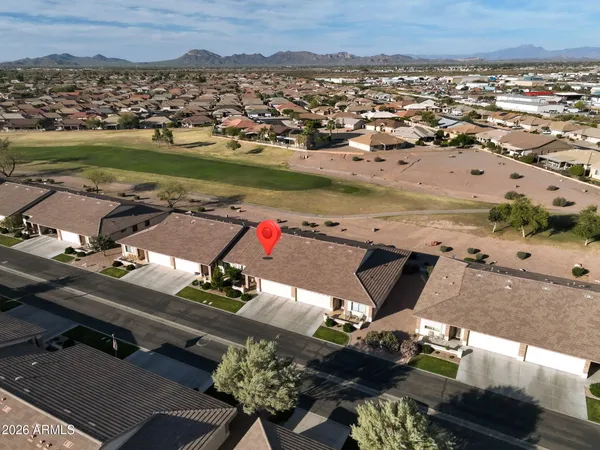 an aerial view of a houses with a lake