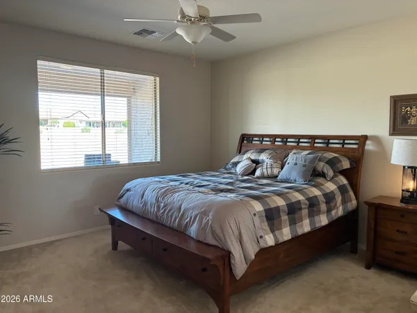 a bedroom with a bed and window