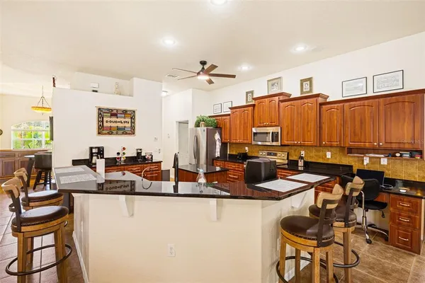 a kitchen with stainless steel appliances a sink stove and cabinets