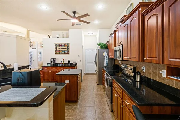 a living room with kitchen view and a dining table