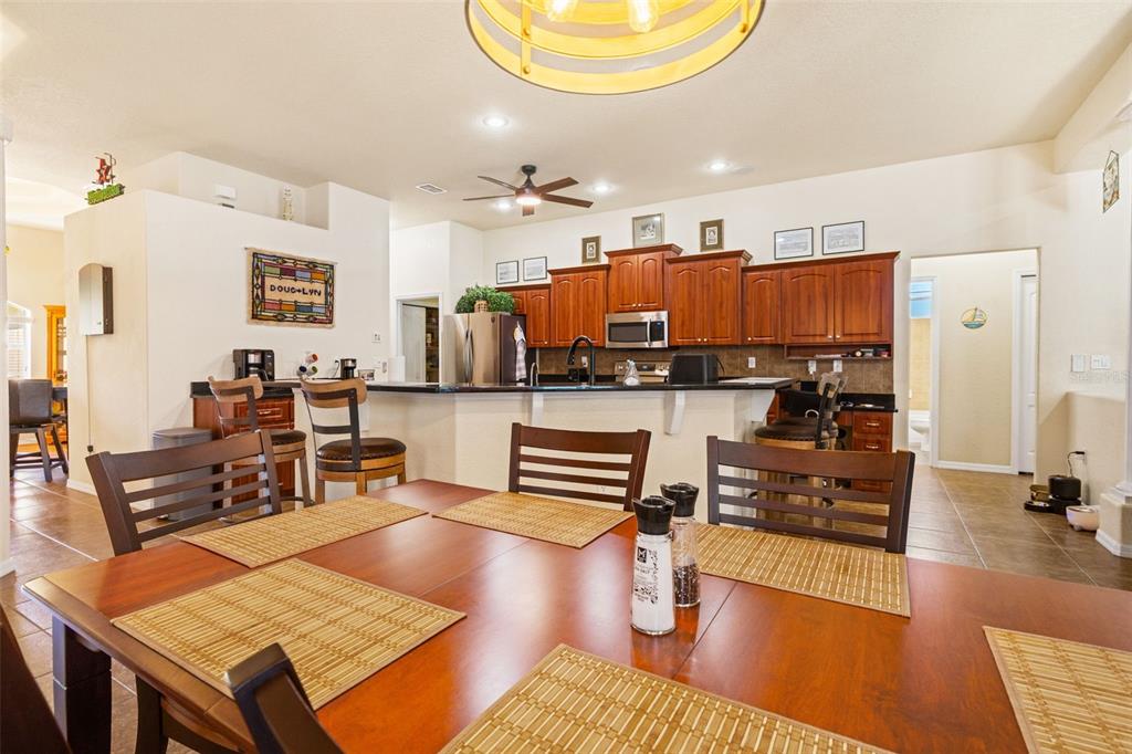 10288 Ridge Top Loop Weeki Wachee, FL 34613 - Photo 17 of 61 a living room with kitchen view and a dining table