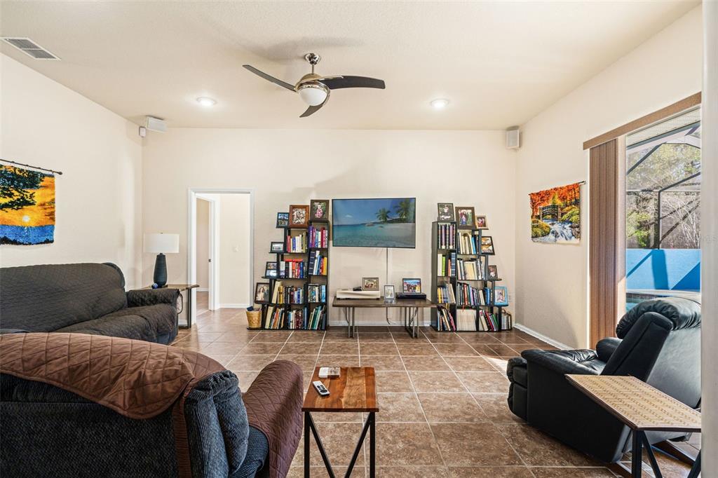 10288 Ridge Top Loop Weeki Wachee, FL 34613 - Photo 18 of 61 a living room with furniture and a flat screen tv