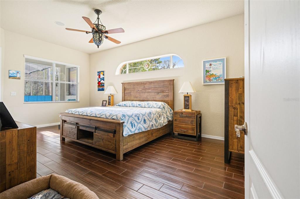 10288 Ridge Top Loop Weeki Wachee, FL 34613 - Photo 21 of 61 a bedroom with a bed wooden floor and window