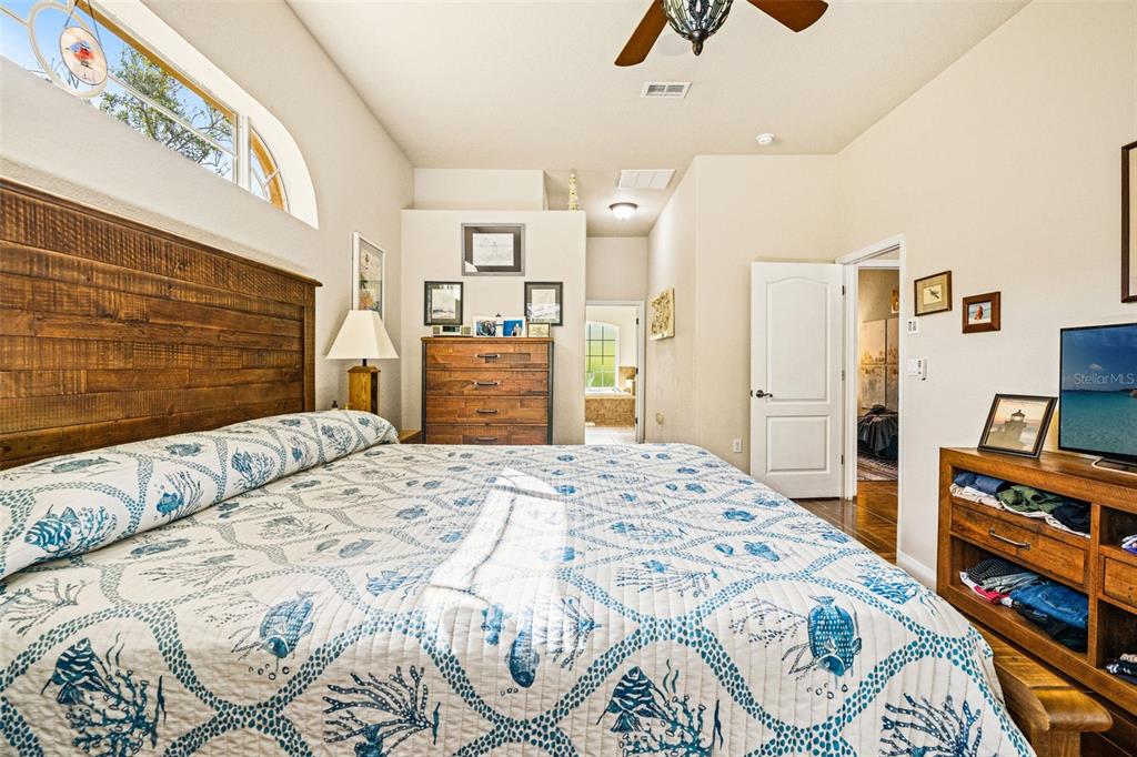 10288 Ridge Top Loop Weeki Wachee, FL 34613 - Photo 22 of 61 a bedroom with a bed and a flat screen tv