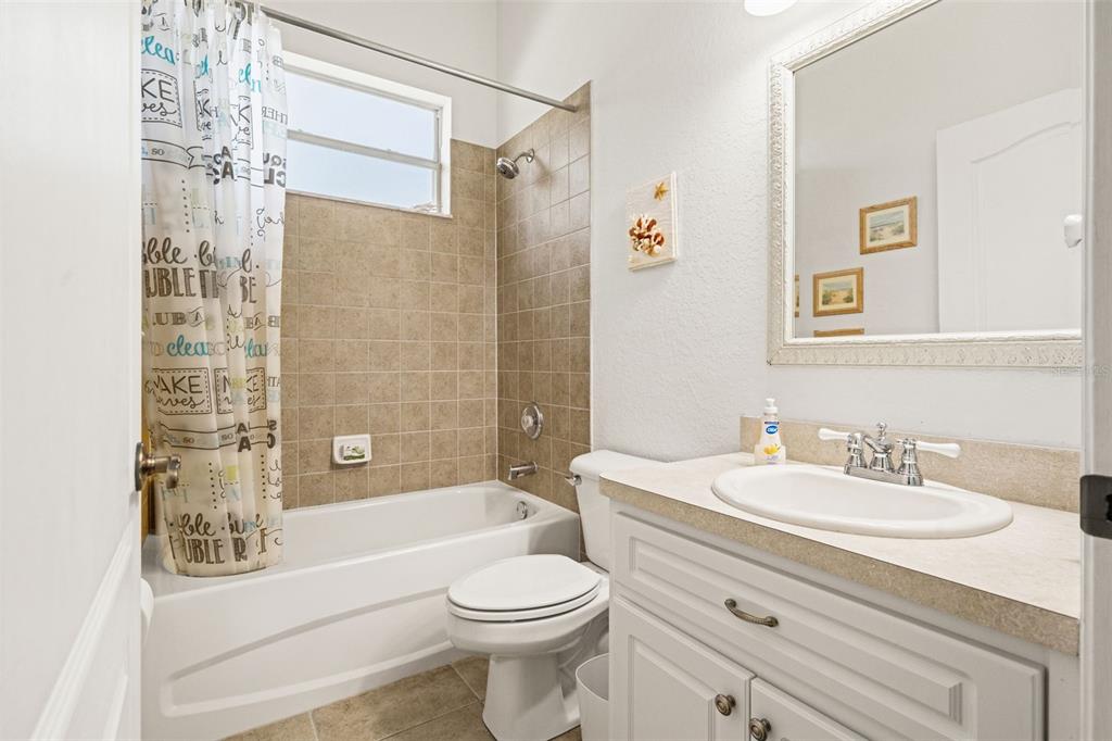 10288 Ridge Top Loop Weeki Wachee, FL 34613 - Photo 28 of 61 a bathroom with a sink a toilet and shower