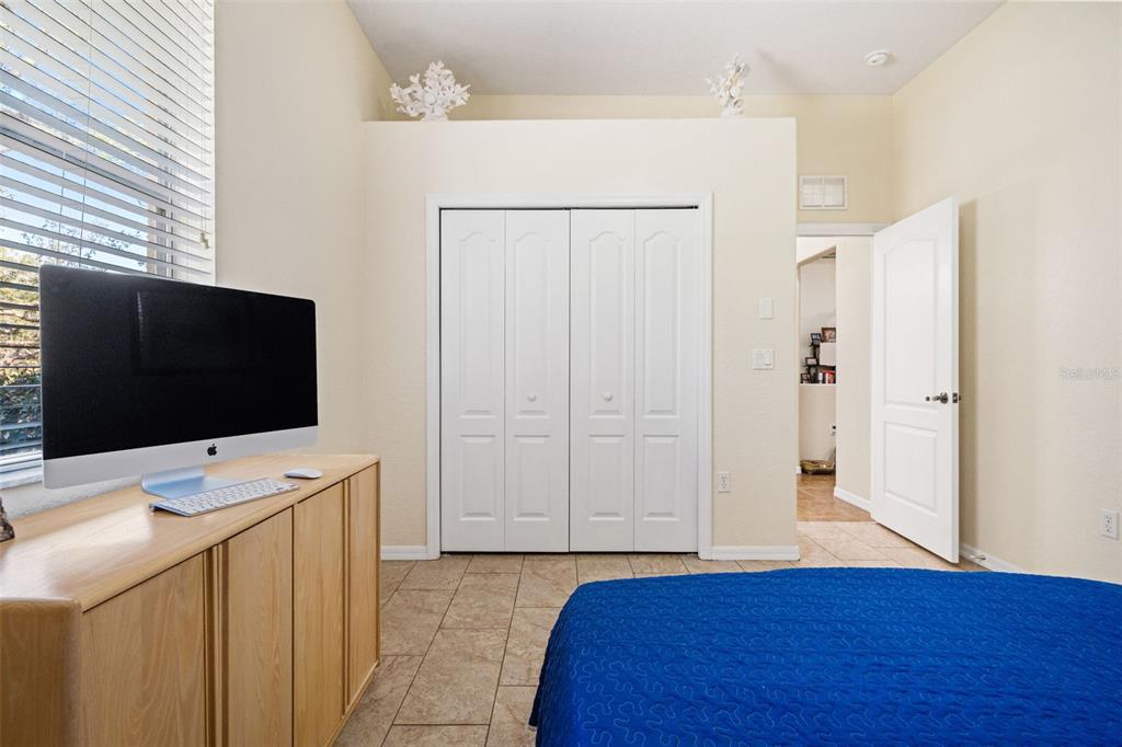 10288 Ridge Top Loop Weeki Wachee, FL 34613 - Photo 30 of 61 a bedroom with a bed and a flat screen tv