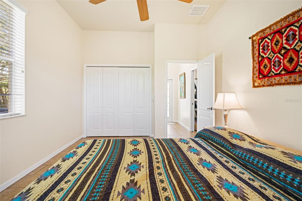 10288 Ridge Top Loop Weeki Wachee, FL 34613 - Photo 34 of 61 a bedroom with bed and a book shelf