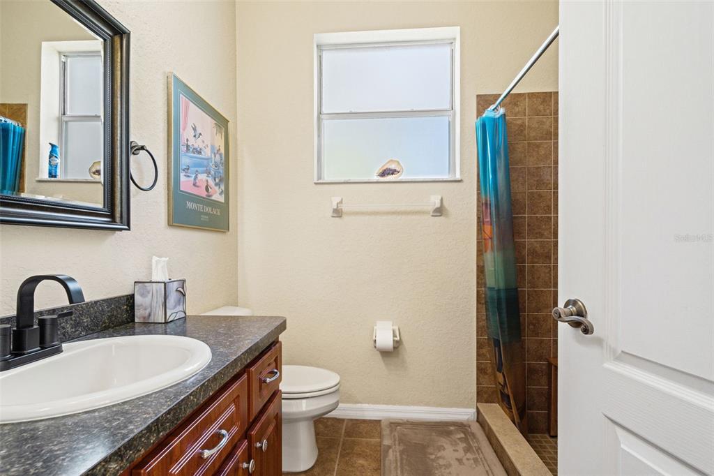 10288 Ridge Top Loop Weeki Wachee, FL 34613 - Photo 35 of 61 a bathroom with a granite countertop sink and a mirror
