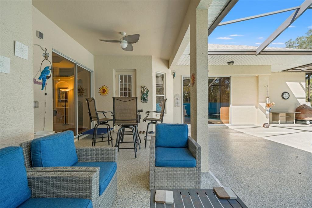 10288 Ridge Top Loop Weeki Wachee, FL 34613 - Photo 38 of 61 a living room with furniture a rug and a dining table