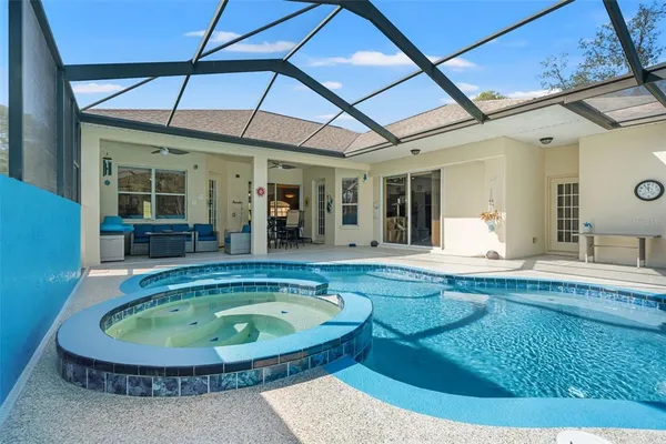 a view of a house with backyard and sitting area