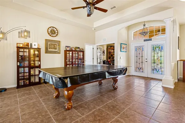 a dining room with furniture and a chandelier