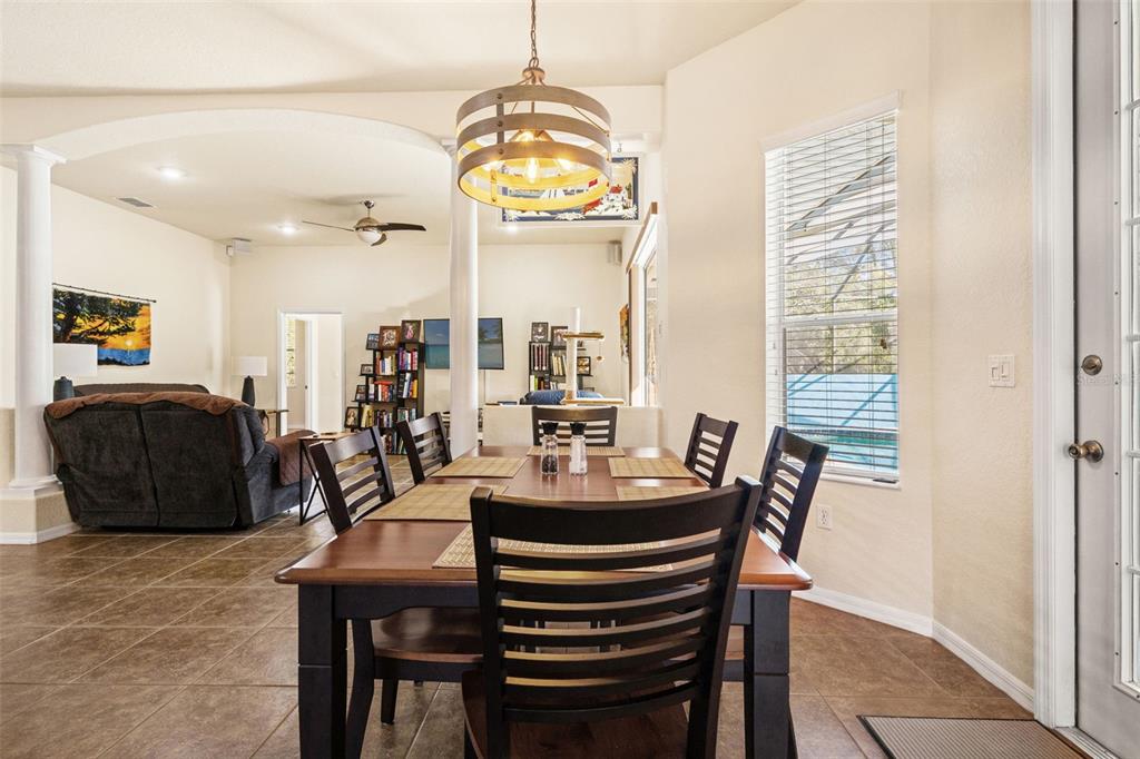 10288 Ridge Top Loop Weeki Wachee, FL 34613 - Photo 10 of 61 a dining room with furniture and a chandelier