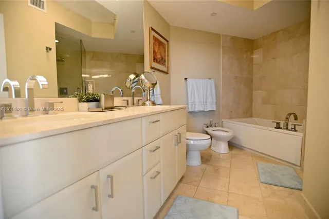 a spacious bathroom with a double vanity sink a toilet and a mirror