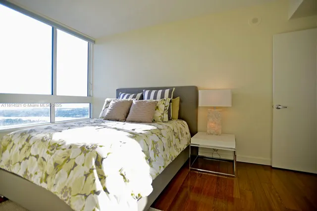 a bed sitting in a bedroom next to a window