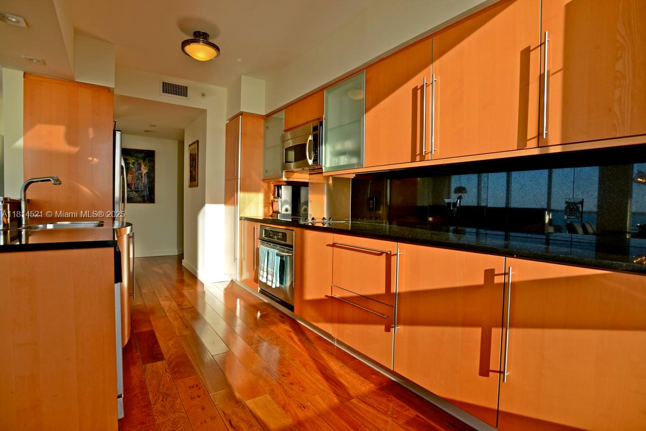 6365 Collins Avenue, Unit 3908 Miami Beach, FL 33141 - Photo 3 of 17 a kitchen with stainless steel appliances a refrigerator sink and microwave