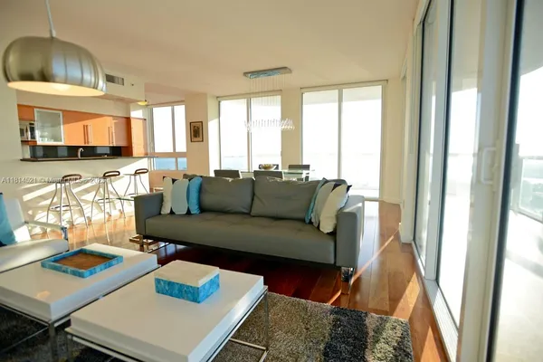 a living room with furniture and a large window