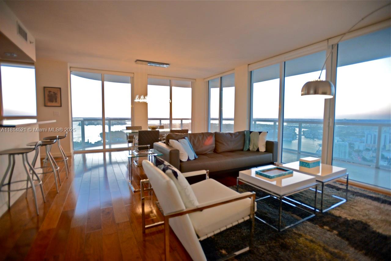 6365 Collins Avenue, Unit 3908 Miami Beach, FL 33141 - Photo 8 of 17 a living room with furniture and a large window