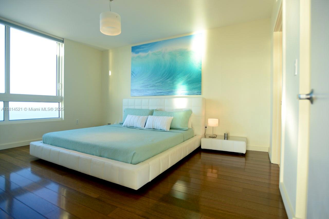 6365 Collins Avenue, Unit 3908 Miami Beach, FL 33141 - Photo 9 of 17 a bedroom with a bed and window