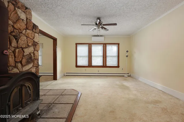 a view of a livingroom with a stove and chandelier wooden floor