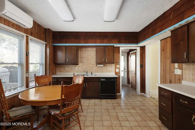 a large kitchen with a table and chairs