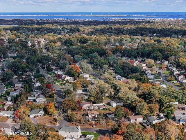 an aerial view of a houses with a swimming pool